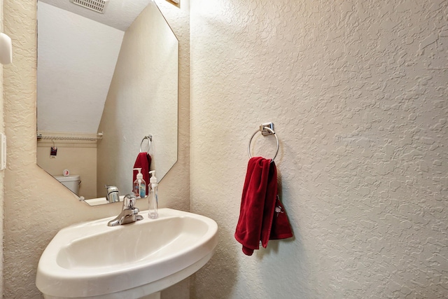 bathroom featuring sink and toilet