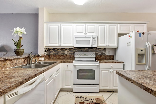 kitchen with white cabinetry, light tile patterned floors, and white appliances