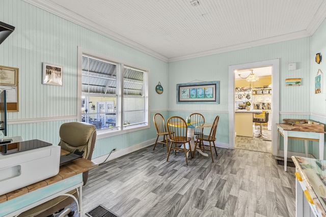 home office featuring crown molding, wood finished floors, and a chandelier