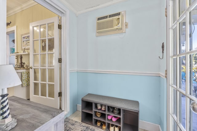 doorway to outside with ornamental molding and a wall unit AC