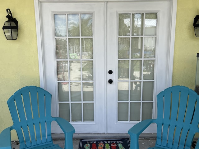 entryway with a textured wall and french doors