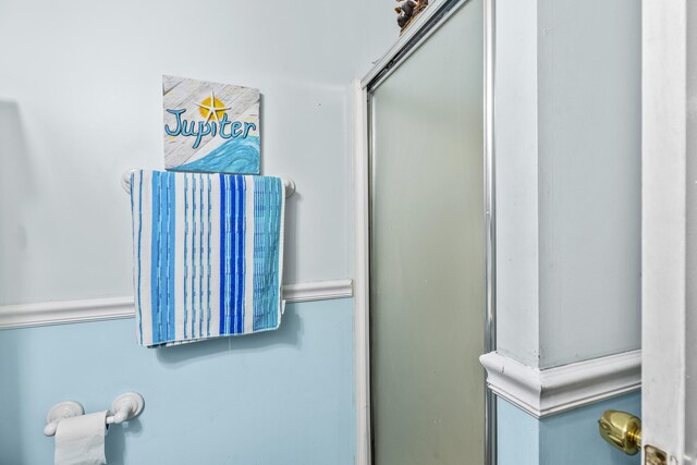 bedroom with multiple windows and an AC wall unit