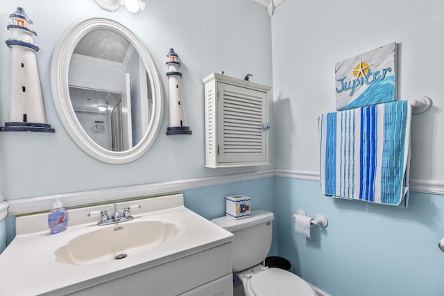 bathroom featuring vanity and toilet