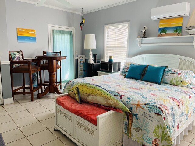 bedroom featuring a wall unit AC, light tile patterned floors, and ornamental molding