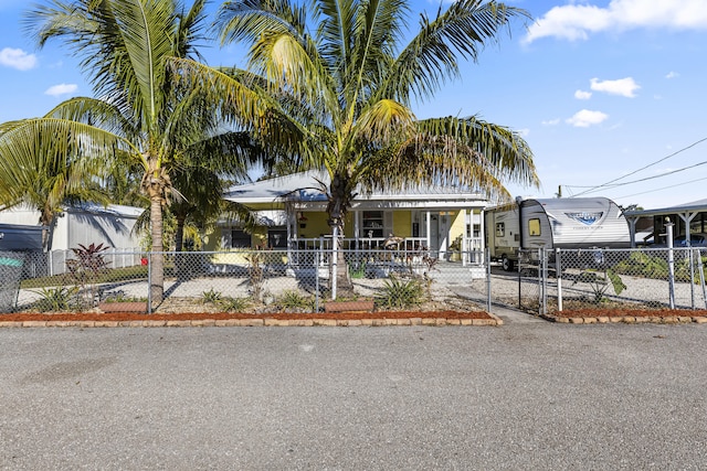 view of front of home with a fenced front yard and a gate