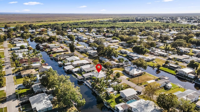 aerial overview of property's location with a large body of water and nearby suburban area
