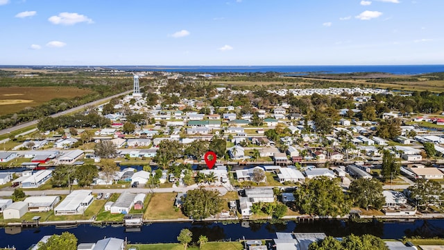 view of property location with a large body of water and nearby suburban area