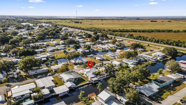 drone / aerial view featuring a water view and a residential view