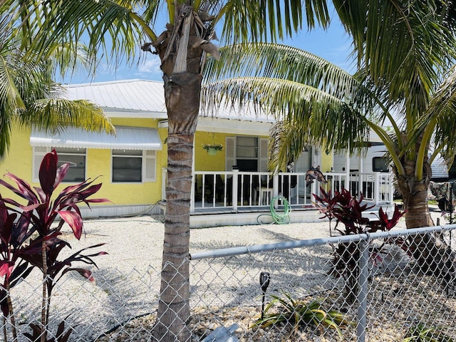 view of front of home featuring metal roof and a porch