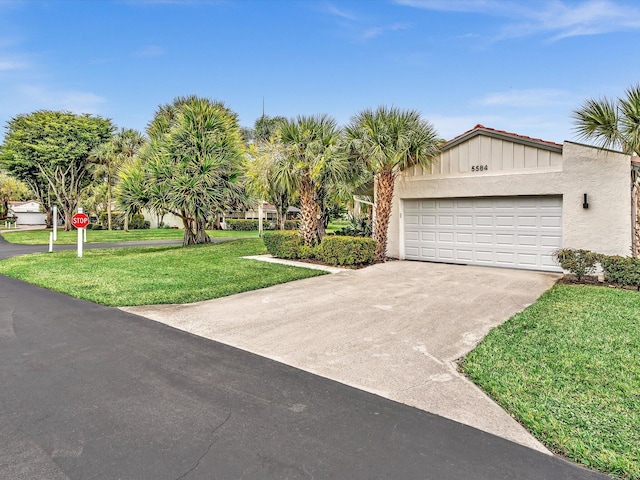 view of front of property featuring a garage and a front yard