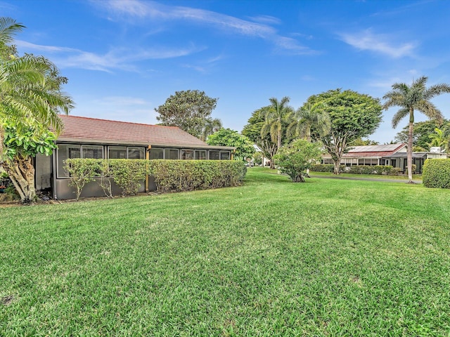 view of yard featuring a sunroom