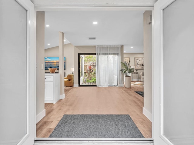 corridor with light hardwood / wood-style floors