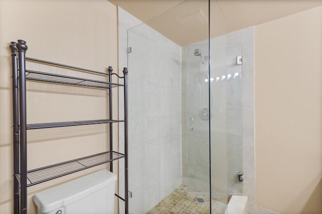 full bath featuring a stall shower and toilet