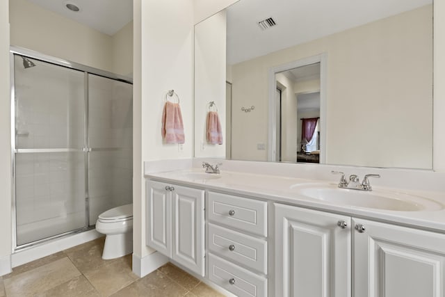 full bath featuring toilet, a stall shower, and a sink