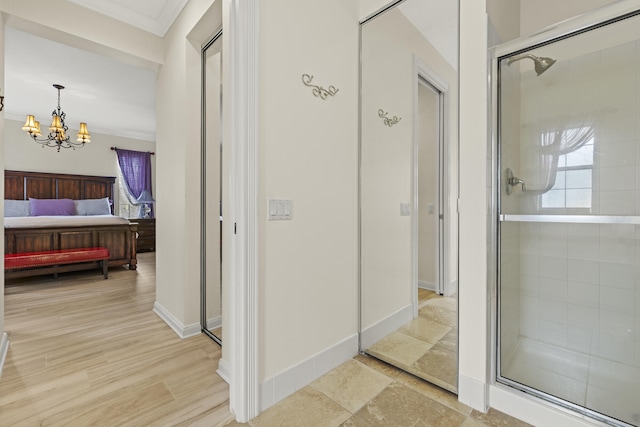 interior space with a stall shower, crown molding, and ensuite bath