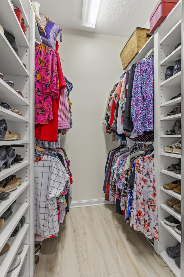 spacious closet featuring wood finished floors