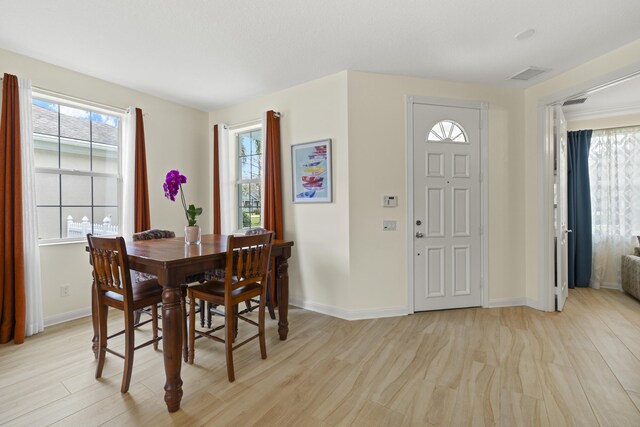 living room with light wood finished floors and visible vents