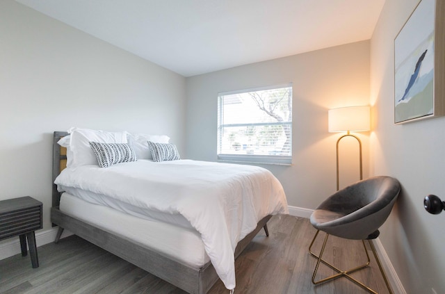 bedroom featuring baseboards and wood finished floors