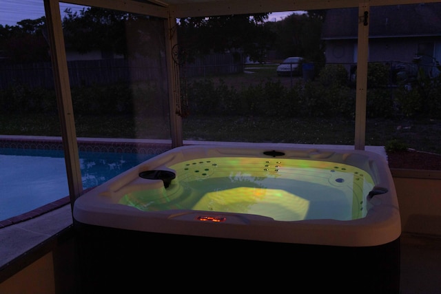 exterior space with a fenced in pool, a jacuzzi, and fence