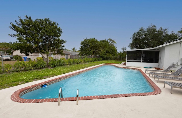 view of pool featuring a fenced in pool, a sunroom, a fenced backyard, a yard, and a patio area