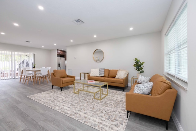 living room featuring visible vents, wood finished floors, and recessed lighting