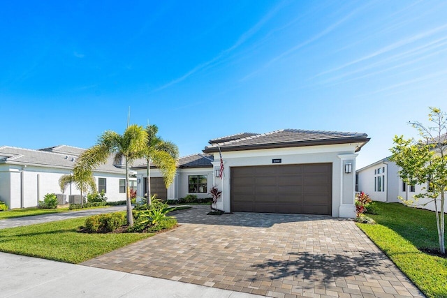 view of front of house with a garage and a front yard