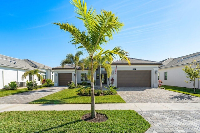 ranch-style house featuring a garage and a front yard