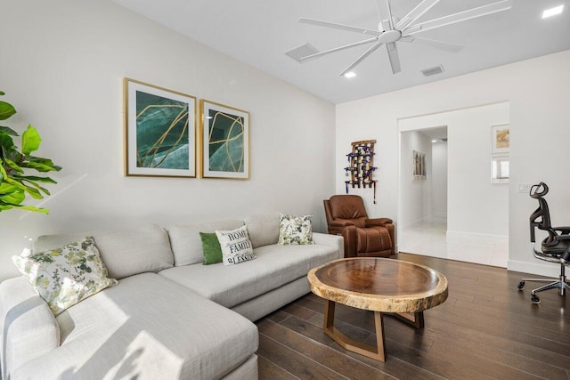 living room featuring ceiling fan and dark hardwood / wood-style flooring