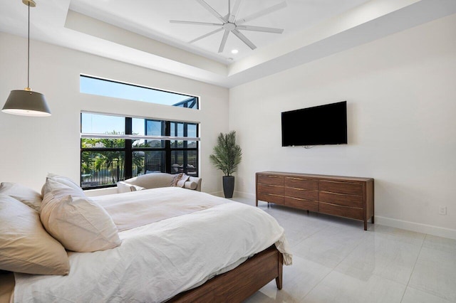 bedroom with a tray ceiling and ceiling fan