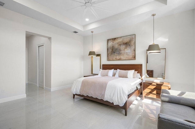 bedroom featuring ceiling fan and a tray ceiling