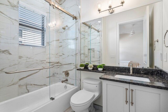 full bathroom featuring bath / shower combo with glass door, vanity, ceiling fan, and toilet