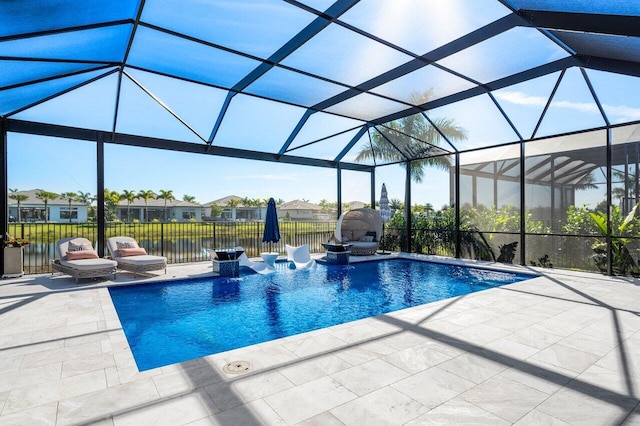 view of swimming pool with a water view, a patio, and glass enclosure