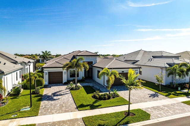 view of front of home with a garage and a front yard