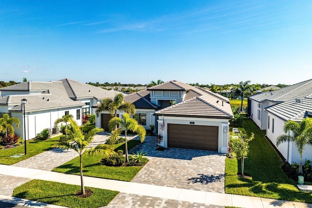 view of front facade featuring a garage and a front lawn