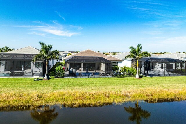 back of property featuring a lanai and a water view