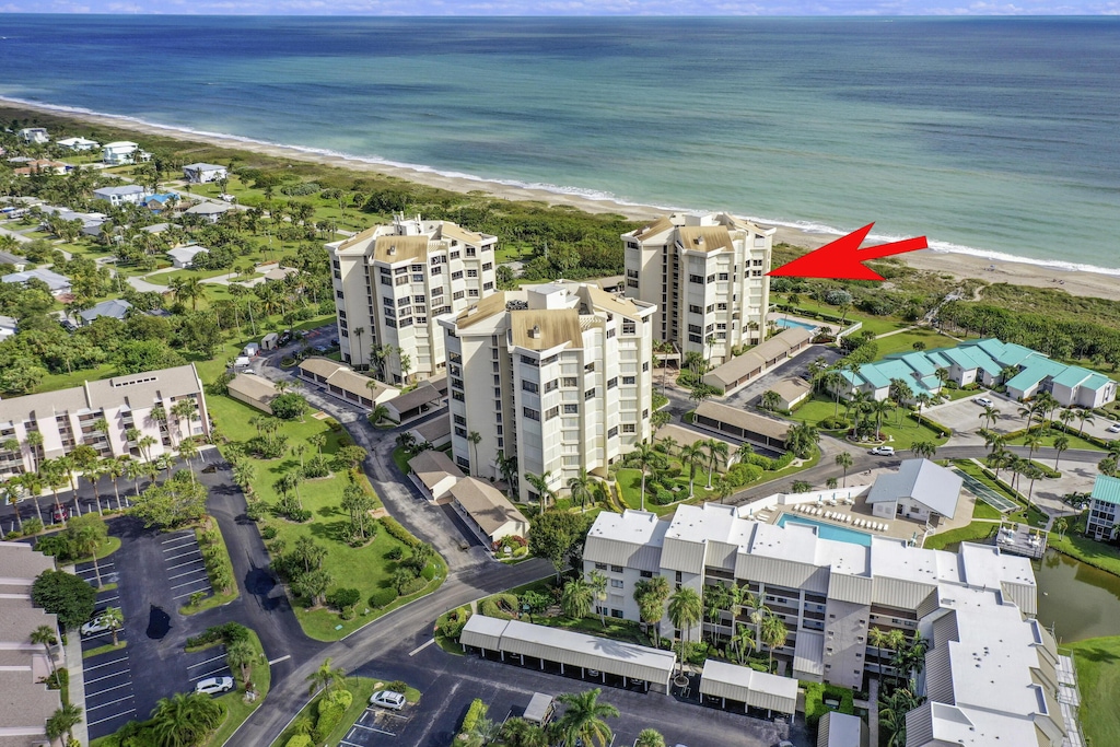 aerial view featuring a view of the beach and a water view