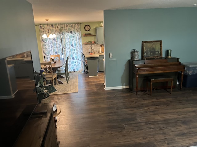 dining space with dark hardwood / wood-style floors and a chandelier