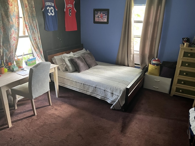 bedroom with dark colored carpet