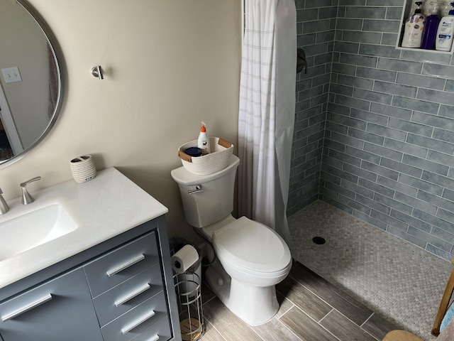 bathroom featuring vanity, toilet, and curtained shower