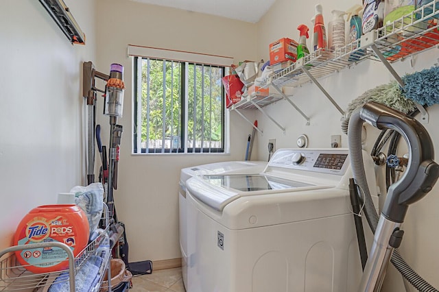 washroom with light tile patterned floors and washing machine and clothes dryer