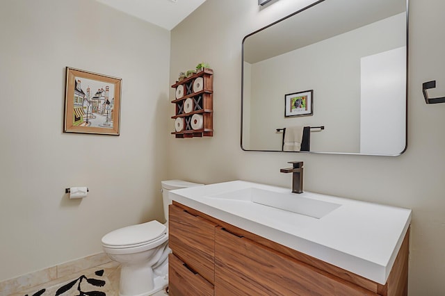 bathroom with vanity, toilet, and tile patterned flooring