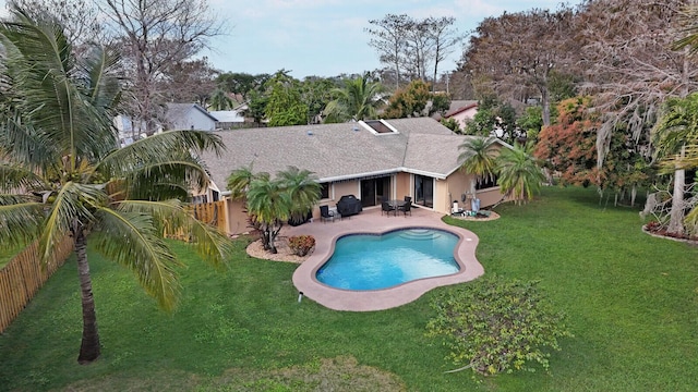 view of swimming pool featuring a yard and a patio