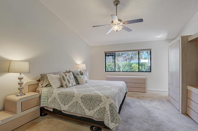 carpeted bedroom with ceiling fan, vaulted ceiling, and a textured ceiling