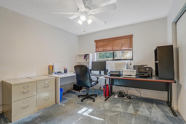 office area featuring a textured ceiling, ceiling fan, and carpet