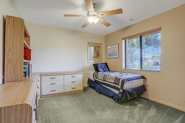 carpeted bedroom with a textured ceiling and ceiling fan