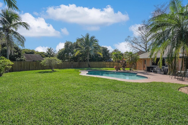 view of pool featuring a lawn and a patio area