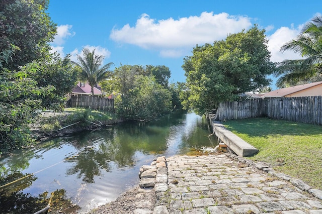 dock area featuring a water view and a yard