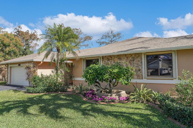 ranch-style house with a garage and a front yard