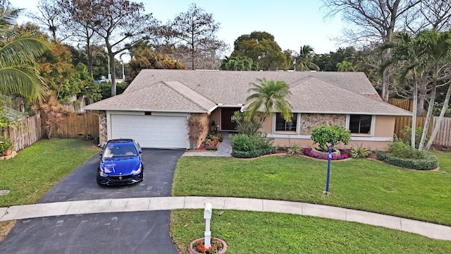 single story home with a garage and a front yard