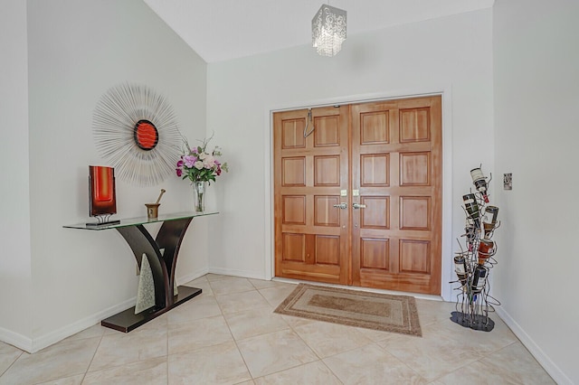 tiled entryway with vaulted ceiling